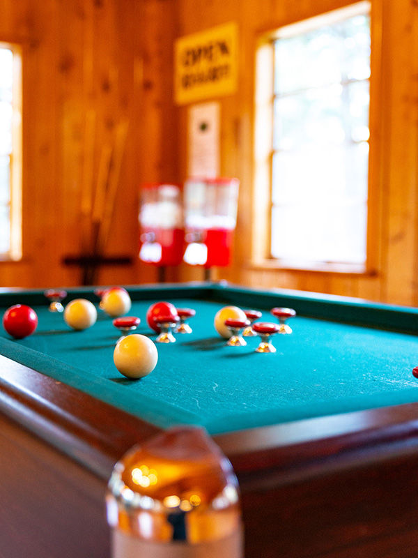 Closeup of bumper pool table in wood paneled game room