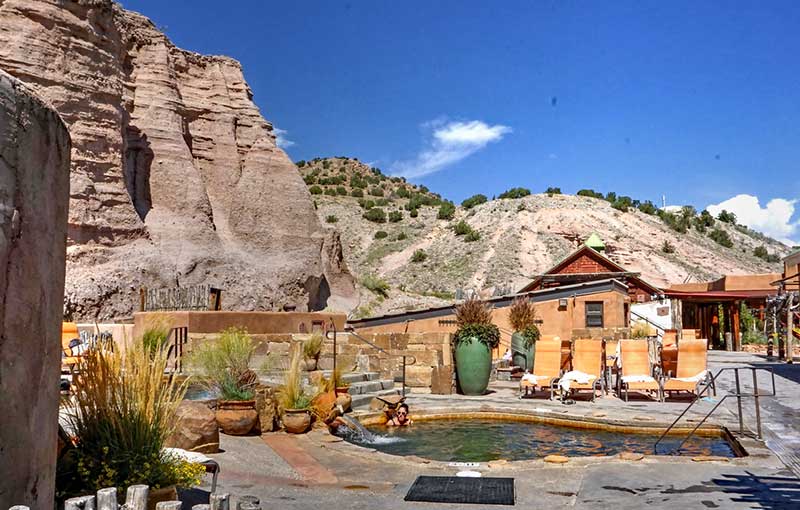 People sitting in a natural hot spring tub at Ojo Caliente