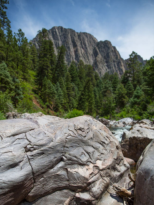 A closeup picture of a river stone with cliffs in the background near Corkins Lodge