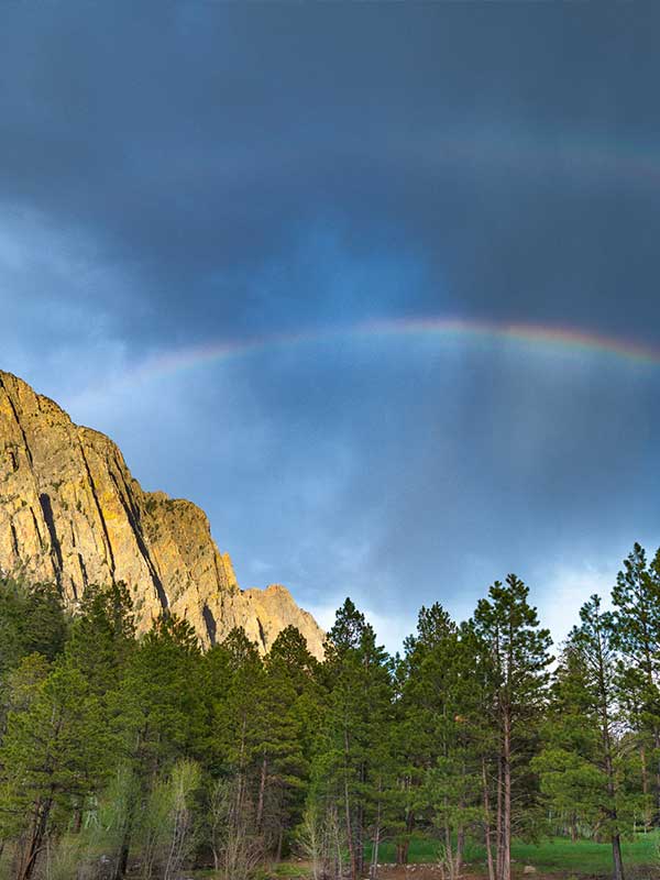 A rainbow over the Rio Brazos cliffs at Corkins Lodge