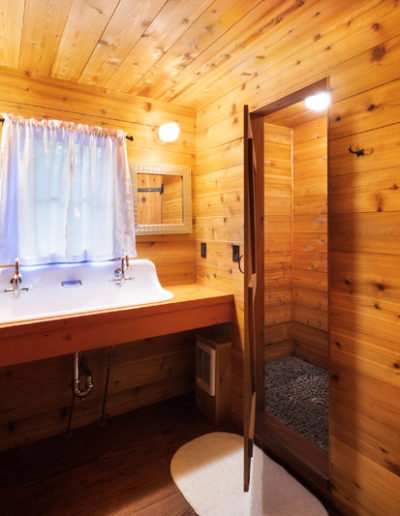 Wooden bathroom with double farm sink and window