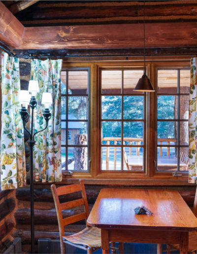 Kitchen table and chairs with curtains in the Ponderosa cabin