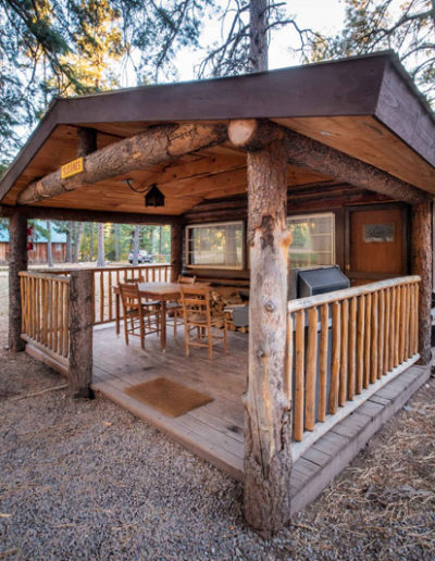 Exterior of Sloans Cabin wooden logs and patio porch deck