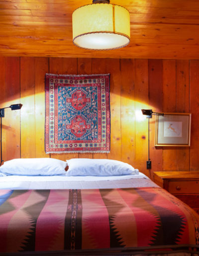 View of large bed and bedroom of the Juniper cabin at Corkins Lodge