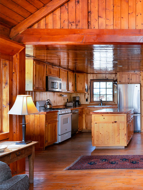 Wooden kitchen of cabin with wood floors