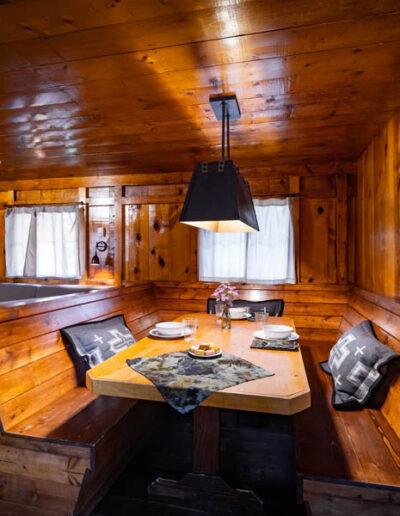 Wooden dining table and wooden benches in a wood cabin