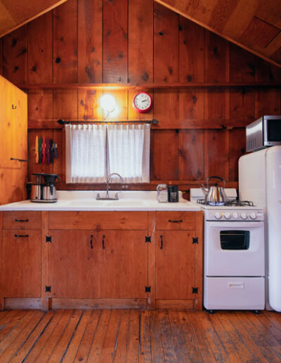 Wood Cabin kitchen with sink, stove and fridge
