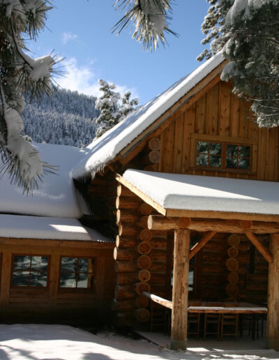 Log House Cabin blanketed with snow and icicles