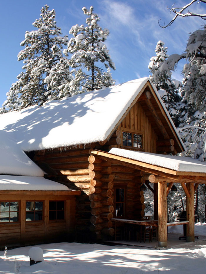 Log House Cabin blanketed with snow and iciciles