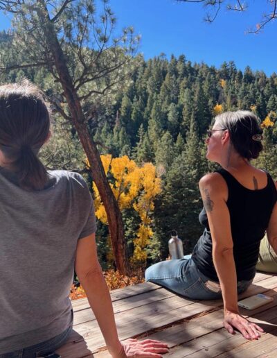 Three women sitting looking at a view