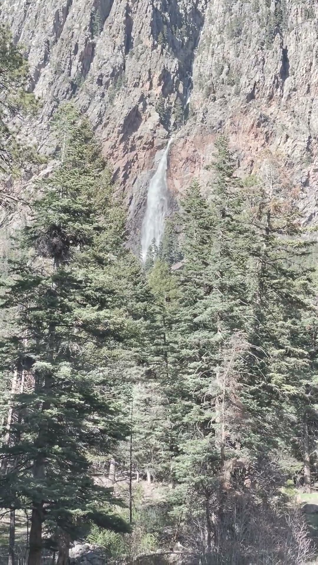Steep waterfall flowing down rock cliffs